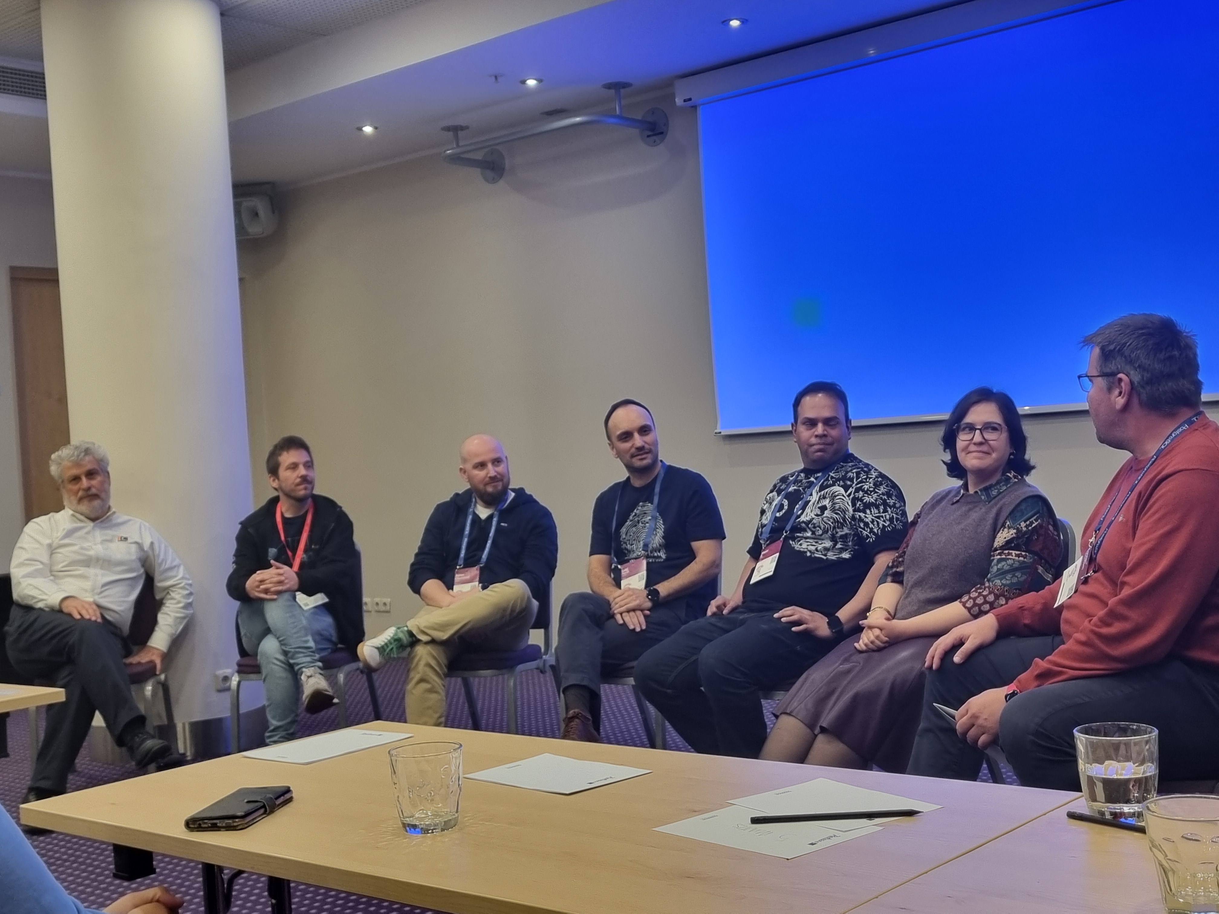 Panelists (from left to right) include Bruce Momjian, Miguel Toscano, Adrien Obernesser, Luigi Nardi, Mayuresh B, Gülçin Yıldırım Jelínek, Torsten Steinbach